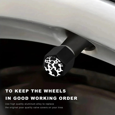 Close-up of Dope Cow Print Tire Valve Stem Cap installed on wheel, showcasing hexagonal shape and cow print pattern.