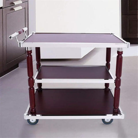 Heavy Duty Industrial Kitchen Bar Cart With Built In Wine Rack And Three Tier Storage Shelves On Smooth Rolling Casters Vintage Wood Steel Serving Trolley Game Day Ready Patio Go To in a kitchen with dark cabinets.