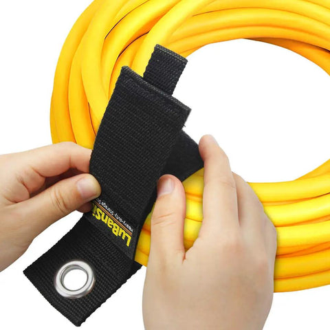 Hands fastening yellow cord with 9 Pack Heavy Duty Extension Cord Holder Organizers For Garage Wall Storage 13 Inch Cord Straps Easy Dispense And Cable Management Keeps Cords Neat Safe And Ready To Use