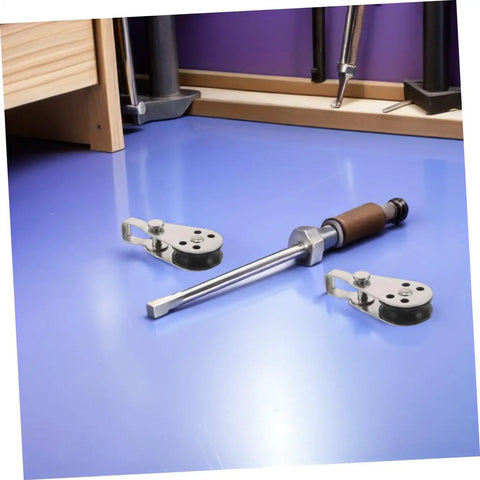4pc Stainless Steel Pulley Blocks For Kayak And Boat Anchor placed on blue surface with screwdriver and tools in background.