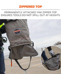 Worker holding 5973 Large Nylon Hoist Bucket Tool Bag With D-Rings and Zipper Top Gray, showing YKK zipper top.