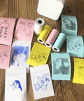 Twenty Pack Square Thermal Receipt Paper For Mini Pos Printers Self Adhesive Photo Sticker Rolls in various colors with printed designs.