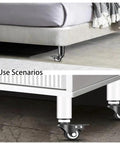 Heavy Duty Adjustable Furniture Legs With Swivel Casters, 4 Piece, shown on bed and cabinet with 360 degree rotation in white.