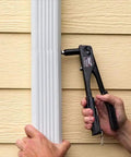 Manual Rivet Gun Kit For Metal, Fabric, Leather And Auto Repair in use on vertical metal siding