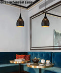 Industrial Wrought Iron Pendant Light Adjustable Single Head E27 Chandelier for Kitchen Island hanging above a cozy coffee shop seating area.