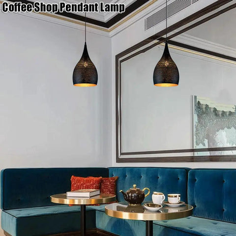 Industrial Wrought Iron Pendant Light Adjustable Single Head E27 Chandelier for Kitchen Island hanging above a cozy coffee shop seating area.