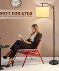 Woman reading under Three Head Arc Floor Lamp With Adjustable Arms Modern Farmhouse LED Standing Lamp With Hanging Drum Shades