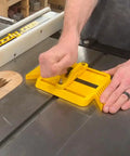 Adjustable Magnetic Featherboard For Table Saws And Router Tables Locks Stock Dead Tight Against Fence securing a wood piece on a table saw.