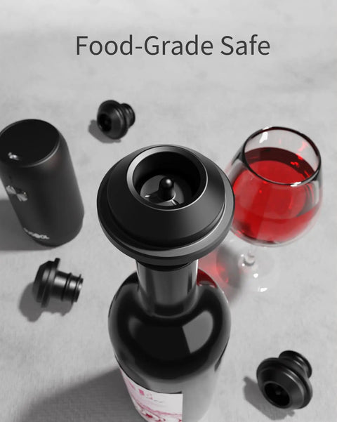 Rechargeable Wine Saver Pump With Vacuum Stopper Set sealing a red wine bottle, glass of wine, and reusable stoppers on table.