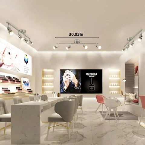 Sleek Modern LED 4-Light Track Lighting Kit With Flush Mount For Wall Or Ceiling, illuminating a stylish retail space.