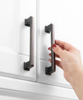Hand using 10 Pack 5 Inch Cabinet Pulls In Oil Rubbed Bronze For Kitchen Cabinets Cupboards Dresser Drawers Bedroom Wardrobes And Bathroom Furniture Hardware Solid Metal Handles With Smooth Rounded Edges For Easy Use And Elegant Finish.