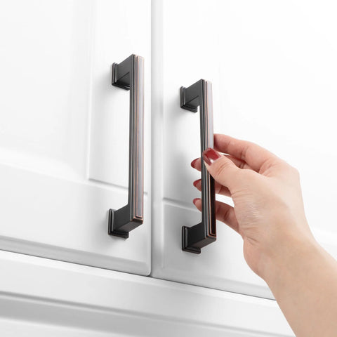 Hand using 10 Pack 5 Inch Cabinet Pulls In Oil Rubbed Bronze For Kitchen Cabinets Cupboards Dresser Drawers Bedroom Wardrobes And Bathroom Furniture Hardware Solid Metal Handles With Smooth Rounded Edges For Easy Use And Elegant Finish.