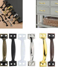 Various door pulls including Vintage Five Inch Door Pulls 2 Pack Bow Shaped Gate Handles In Red Bronze Finish, displayed on handles and drawers.