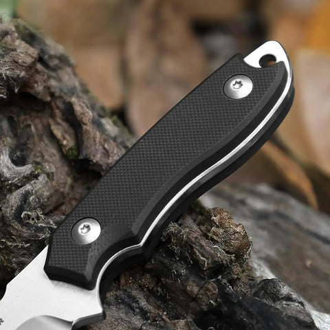 Close-up of EDC Fixed Blade Knife With Kydex Sheath 7 Inch D2 Steel showing the black G10 handle on a natural wood background.