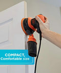Random Orbit Sander 5 Inch 2.4 Amp with Built In Dust Bag in use on a door edge, adjustable 3 position grip visible, compact design