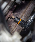 A mechanic uses a socket wrench with a 28 Piece 1/4 Inch And 3/8 Inch Drive Bolt Biter Impact Extraction Socket Set With Laser Etched Size Markings Black Oxide Finish For Corrosion Resistance And Up To Ten Times Longer Impact Life For Quick Pro Level Fastener Rescue In The Garage in a garage.