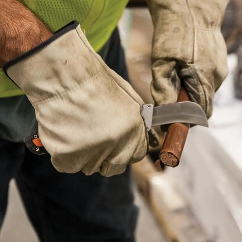 Electricians Utility Knife With Hawkbill Blade For Cable Skinning used by worker in gloves on cable