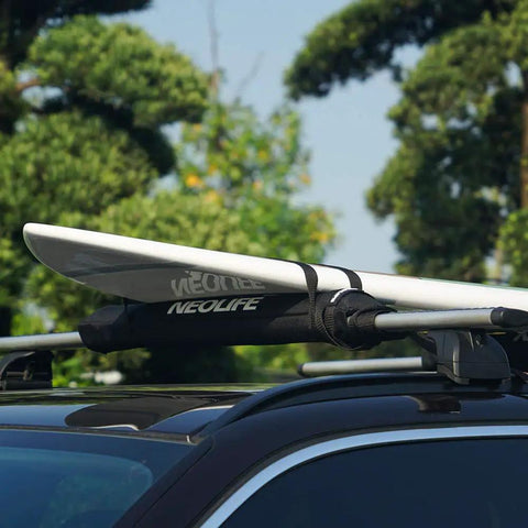 Car roof with soft roof rack pads with two 15 ft tie down straps for surfboard, durable waterproof 600D polyester padding, black pair installed