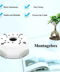 Heavy Duty Aluminum Waterproof Junction Box Mount Bracket For Bullet Security Cameras And Video Surveillance Systems Universal Fit IP66 Rated Weatherproof Cable Management Keeps Wiring Neat And Protected shown on a desk with a book and plant.