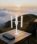 Vertical Axis Wind Turbine Kit 12V 40W with 3 Phase Permanent Magnet Motor on outdoor table by sunset