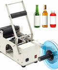 Plug And Play Semi Automatic Round Bottle Labeler With Tight Grip Adjustment Handles 15 To 150Mm Bottles Cranks Out 20 To 40 Labels Daily Zero Fuss on countertop with label roll.