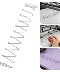Stainless Steel Flat Compression Springs 2 Pc Set, Trapezoidal Wire, High Strength, Space Saving Design For Machinery, Heavy Duty Industrial Spare Parts And Equipment Maintenance, shown on conveyor