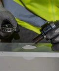Action shot using Optimized Design 10 Gauge Mild Steel Knockout Punch Set With Black Finish Half Inch Punch and Die on metal panel