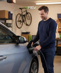 Man using Universal Dual Port Level 2 EV Charging Station With 50 Amp Home Electric Vehicle Setup And Slick 18 Foot Cord.