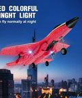 Su-27 RC Airplane With Gyro Stability, Rad 2 Channel Remote, Night Lights flying over cityscape at dusk