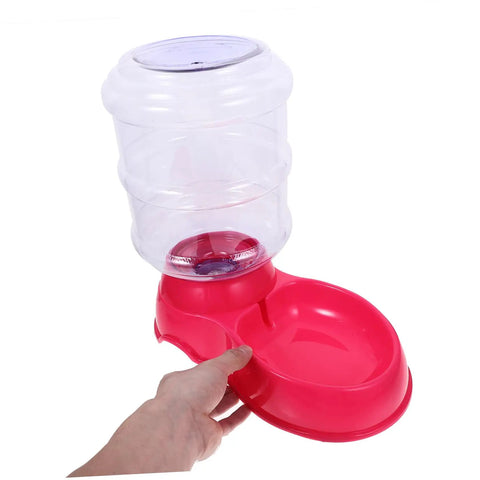 Chill Out As Your Furry Buddies Chow Down On This Pink 3.5L Automatic Pet Feeder And Water Bowl Station featuring a person holding it.
