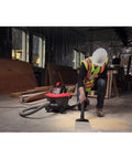 Worker using 6 Gallon Wet Dry Shop Vacuum With Casters 4.25 Peak HP Motor Quiet Scroll Noise Reduction Pro Locking Hose on floor