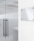 Mirror Screw Decorative Cap Covers 10mm Brushed Stainless Steel Set of 4 installed on glass sign next to metal door in office.