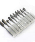 Front view of a 10-piece double-cut carbide burr set with 3 mm shanks in a clear plastic holder