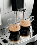Fully Automatic Espresso And Cappuccino Maker With Precision Burr Grinder For Smooth Milk Frothing And Solid Stainless Steel Cabinet Profile pouring espresso into two glass cups.