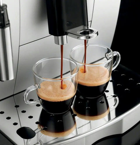 Fully Automatic Espresso And Cappuccino Maker With Precision Burr Grinder For Smooth Milk Frothing And Solid Stainless Steel Cabinet Profile pouring espresso into two glass cups.