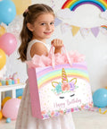 Girl holding 13 Inch Unicorn Gift Bag With Greeting Card And Tissue Paper For Baby Girls And Kids Birthday Party Rainbow Unicorn Theme