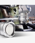 Heavy Duty Electric Espresso Tamper Game Changer With 16 Adjustable Pressure Levels Auto Compresses 58mm Portafilter Locks In Your Perfect Shot Daily Black Finish displayed next to espresso machine.
