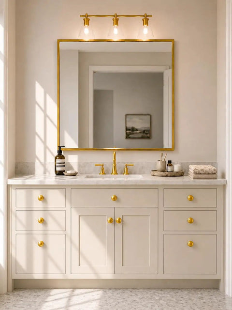 Bathroom vanity with Brushed Satin Gold Wide Base Bifold Closet Door Knobs 4 Pack installed on beige cabinets and mirror frame.