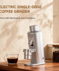 Premium Electric Single Dose Coffee Grinder With 63mm CNC Conical Burrs And Stepless Adjustment Anti Static Ground Collection Bin For Smooth As Silk Espresso And Hit The Spot Pour Over Brewing In Matte Black on wooden countertop with coffee cup.