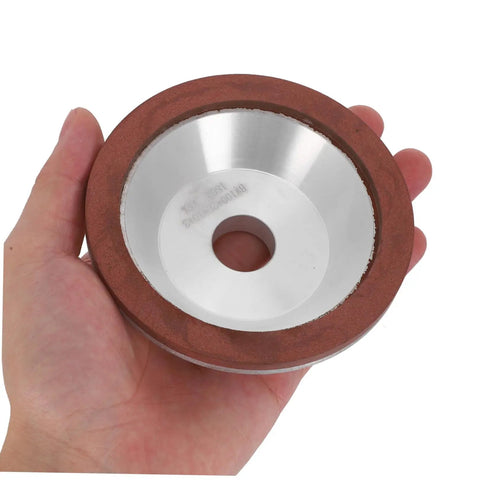 Pro Diamond Cup Grinding Wheel 100mm Silver Concave Bowl that cuts like hell, being held in hand for serious shaping tasks.