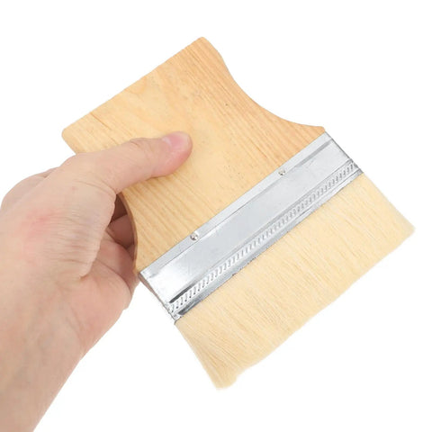 Person holding a brush from Three Piece Wood Handle Furniture Paint Brushes Set For Walls And Wood With Flat Wool Bristle Stain Brushes Pro