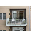 Outdoor Wall Light LED 13 Inch Textured Black With Integrated 3000K Glow on balcony, wet location rated, white diffuser.
