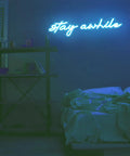 Room with Pink Stay Awhile Neon Sign LED Dimmable Bar Light For Wall Decor USB Powered Cool Neon Light above bed and shelf.