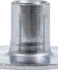 Close-up of a zinc-plated steel pronged tee nut, part of 100 Pcs Pronged Tee Nuts Size 10 32 Zinc Plated Steel T Nuts For Wood And Furniture Assembly Flush Mount Threaded Inserts For Woodworking Cabinets And Diy Projects.