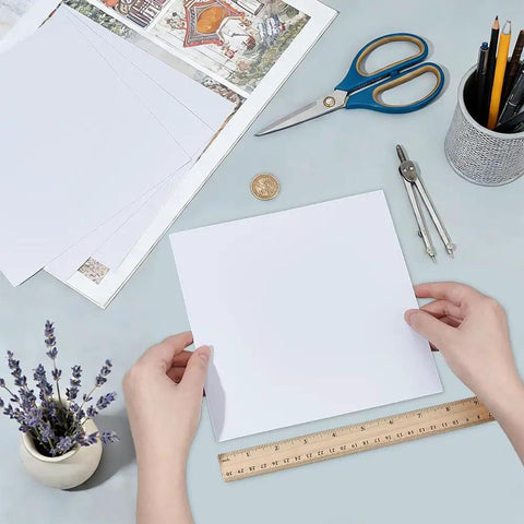 Person holding one of four white ABS plastic sheets 7.87 by 7.87 inches 0.5 mm thick for DIY architectural models and sand table builds.
