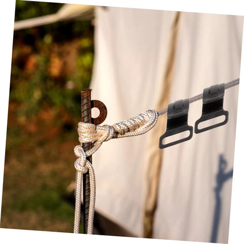 10 Pack Plastic Tent Pole Hooks For Glamping And Camping Gear Hanger attached to a rope outdoors next to a tent.
