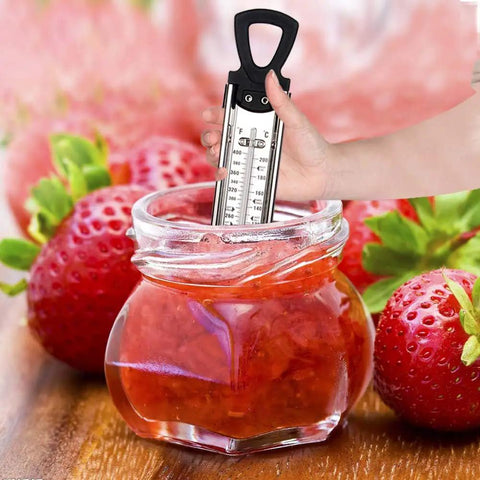 Hand using Stainless Steel Candy And Deep Fry Thermometer With Pot Clip And Handle in strawberry jam