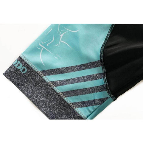 Close-up of teal and black athletic shorts with stripe design and logo on the hem