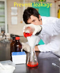 Person in lab coat pouring red liquid through funnel into flask on lab table