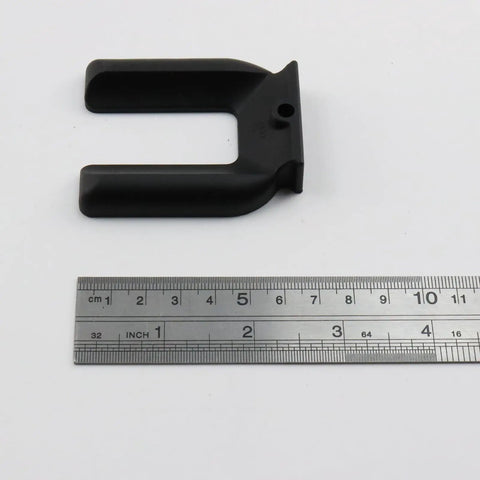 Black plastic wheel stopper from 4Pcs Wheel Stopper Set No Slip Caster Cups For 2 Inch Wheels next to a ruler for scale.